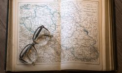 Open book of maps with a pair of spectacles